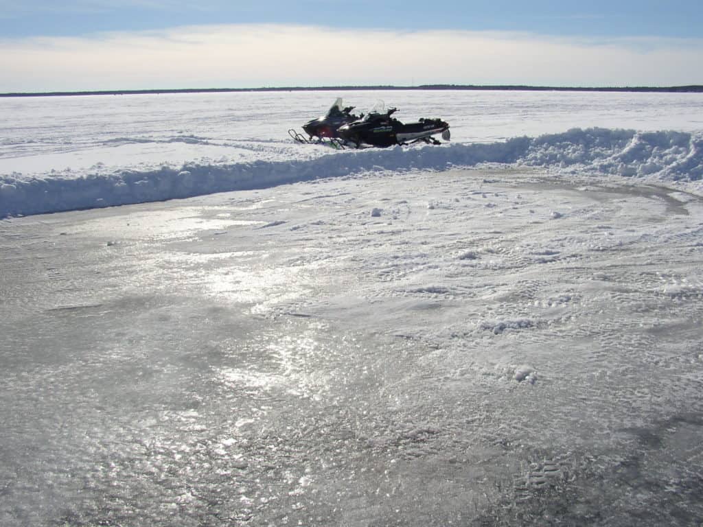 Frozen Lake with Snowmobiles